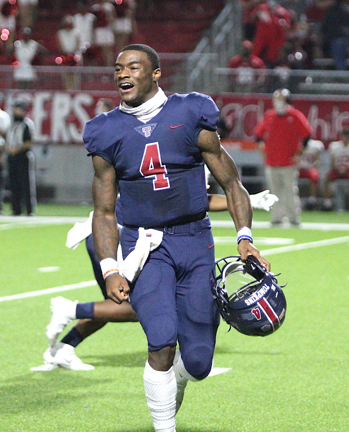 Tompkins senior quarterback Jalen Milroe celebrates after the Falcons' 24-19 win over Katy on Nov. 5 that snapped the Tigers' 75-game district winning streak.